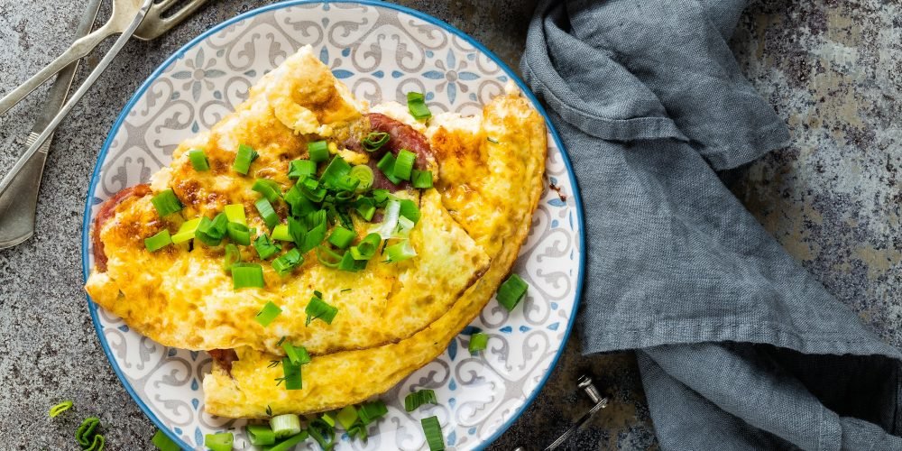 Omelet or omelette with fresh green onion, scrambled eggs